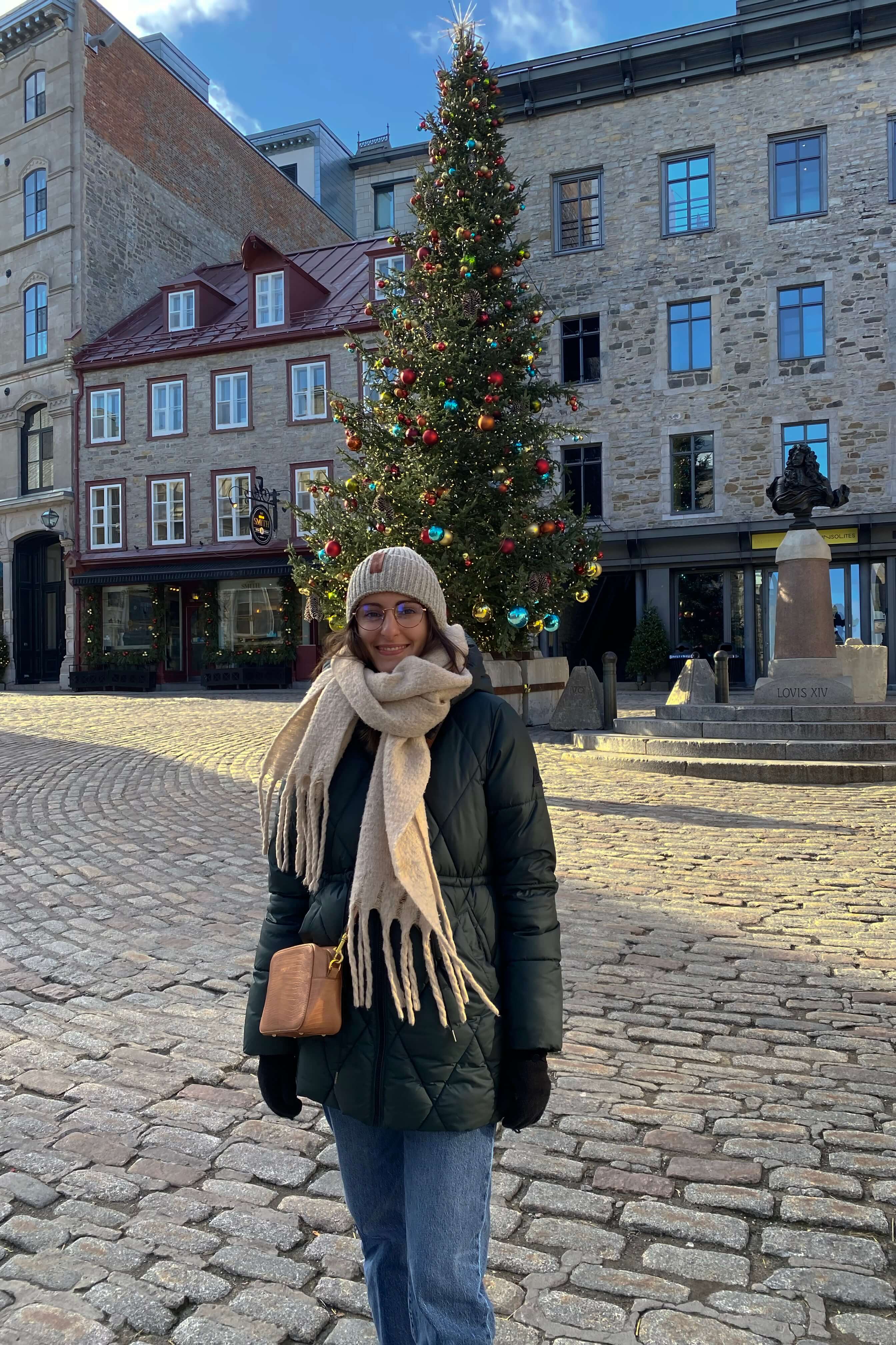 Mélanie posant dehors en hiver devant un bâtiment européen